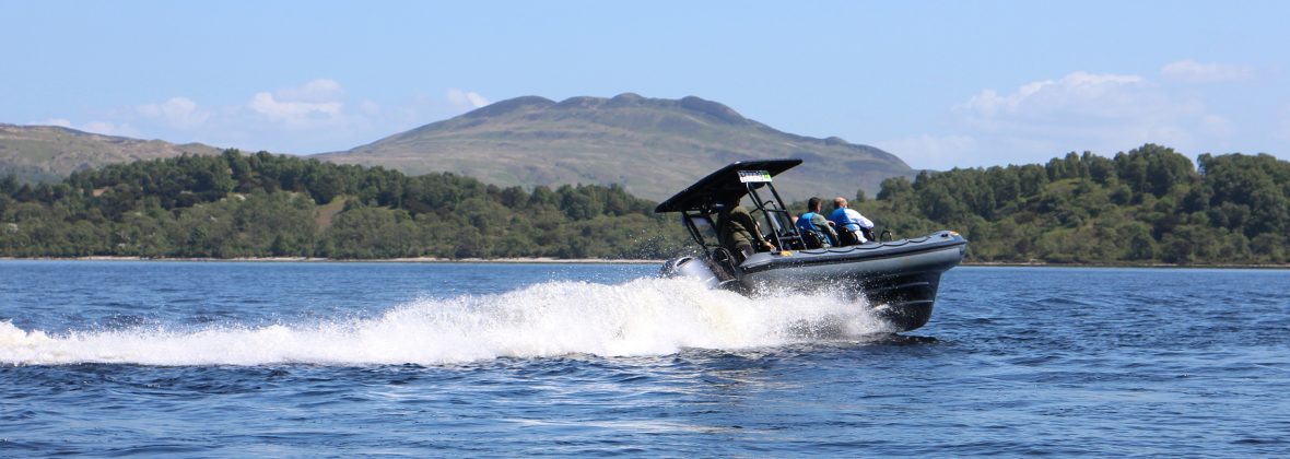 Group on humber speedboat with mountain in background