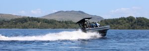 Group on humber speedboat with mountain in background