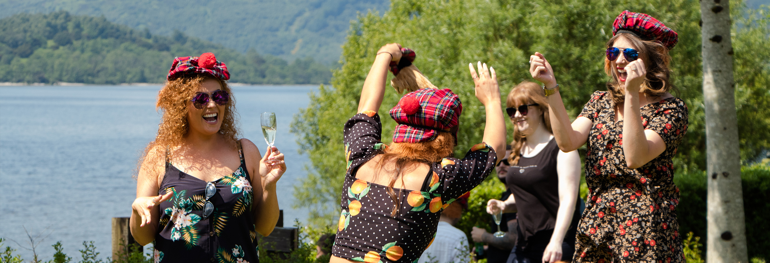 Hen party group dancing and drinking in the sun