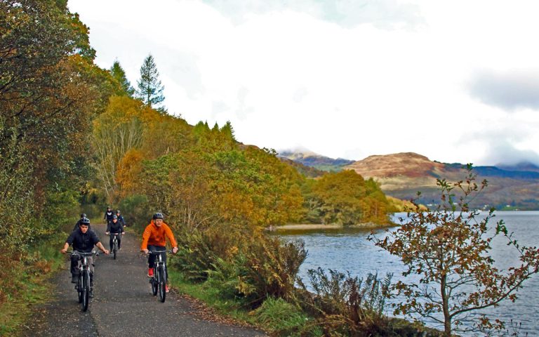 a group cycling on the shores of loch lomond