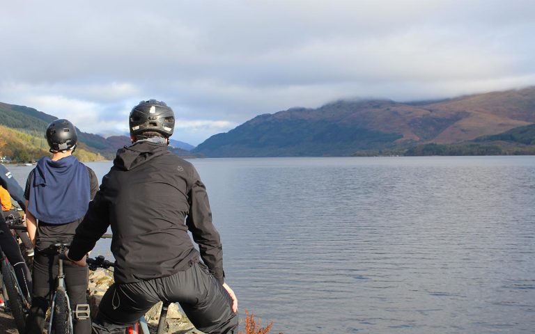 a group of cyclists looking out over loch lomond