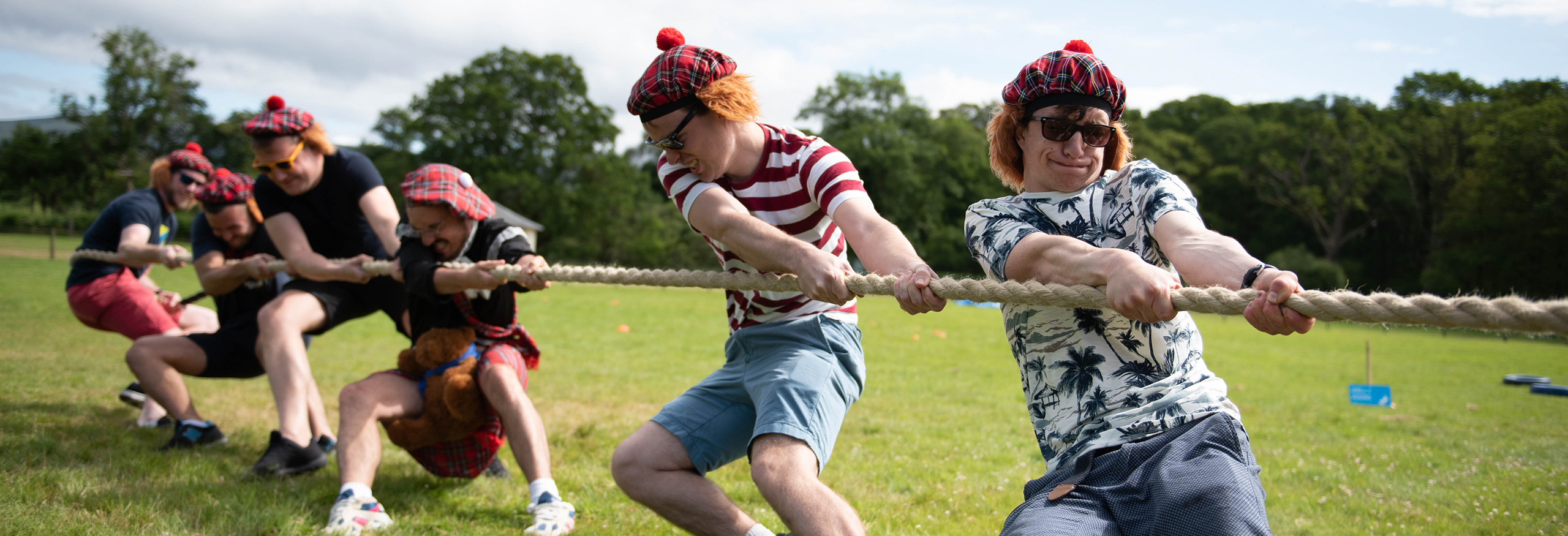 Highland Games stag party group taking part in a Tug O War