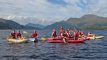 A group of people on paddlesports equipment on loch lomond