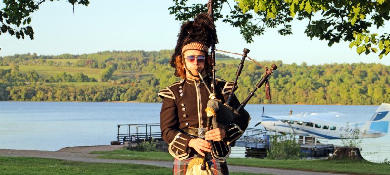 Piper in front of Loch Lomond at corporate highland games