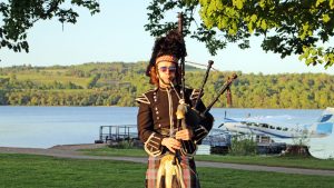 Piper in front of Loch Lomond at corporate highland games