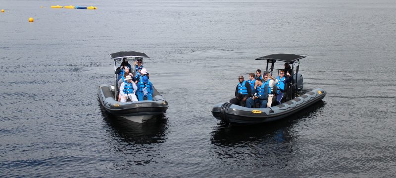 A corporate group on two speedboats at Loch Lomond