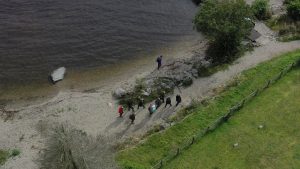 Corporate team taking part in a treasure hunt drone shot