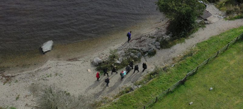 Corporate team taking part in a treasure hunt drone shot