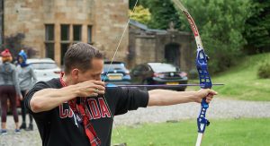 Man with bow and arrow for an archery event
