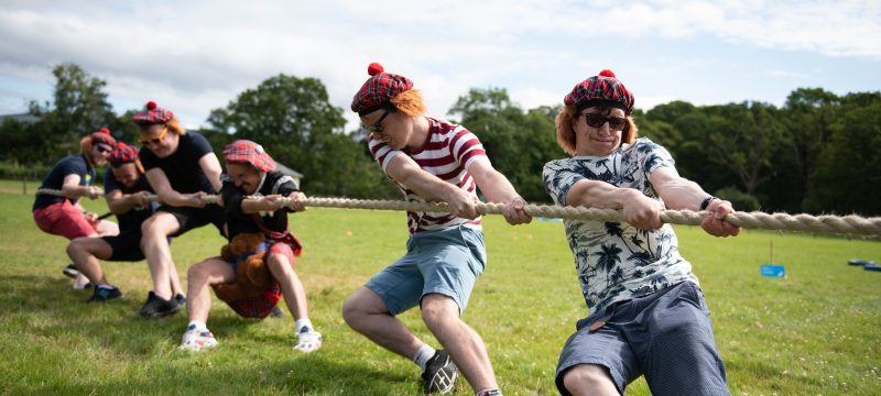 Highland Games stag party group taking part in a Tug O War