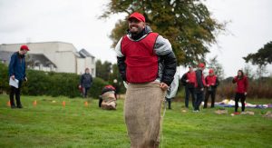 Man taking part in Old skool sports day sack race
